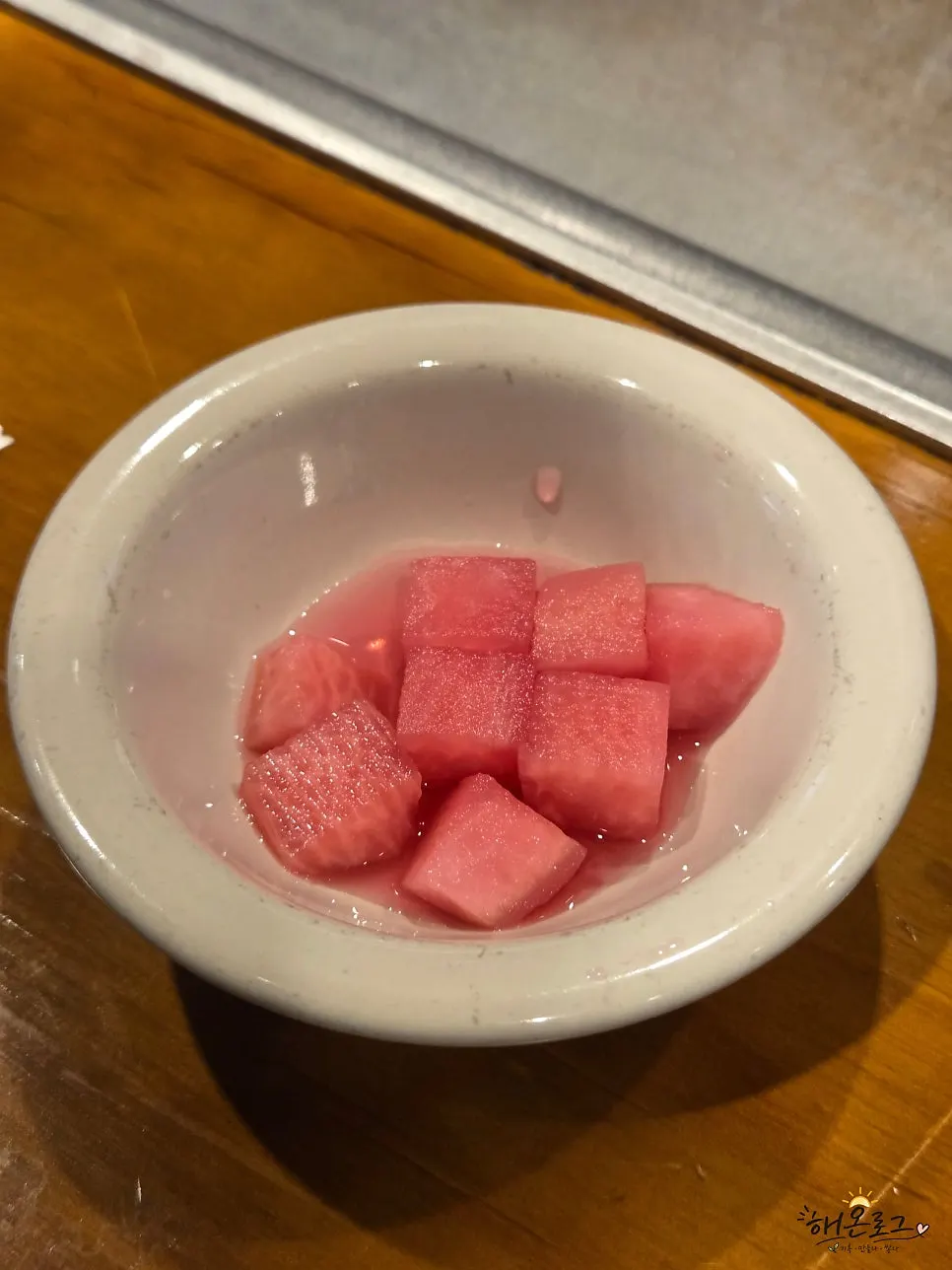 Pink pickled radish served as the house side dish
