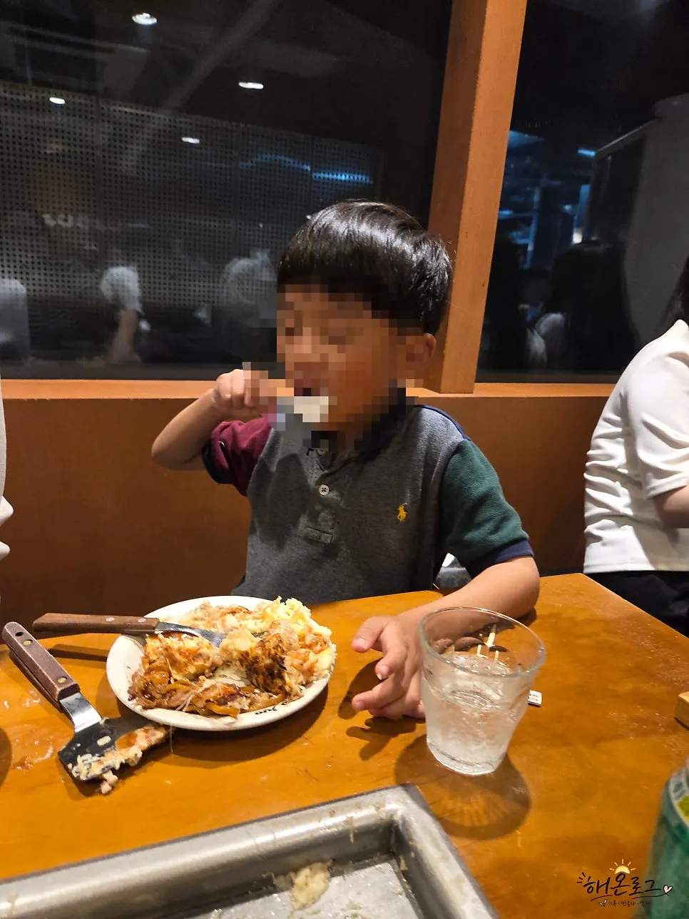 Child eating okonomiyaki enthusiastically