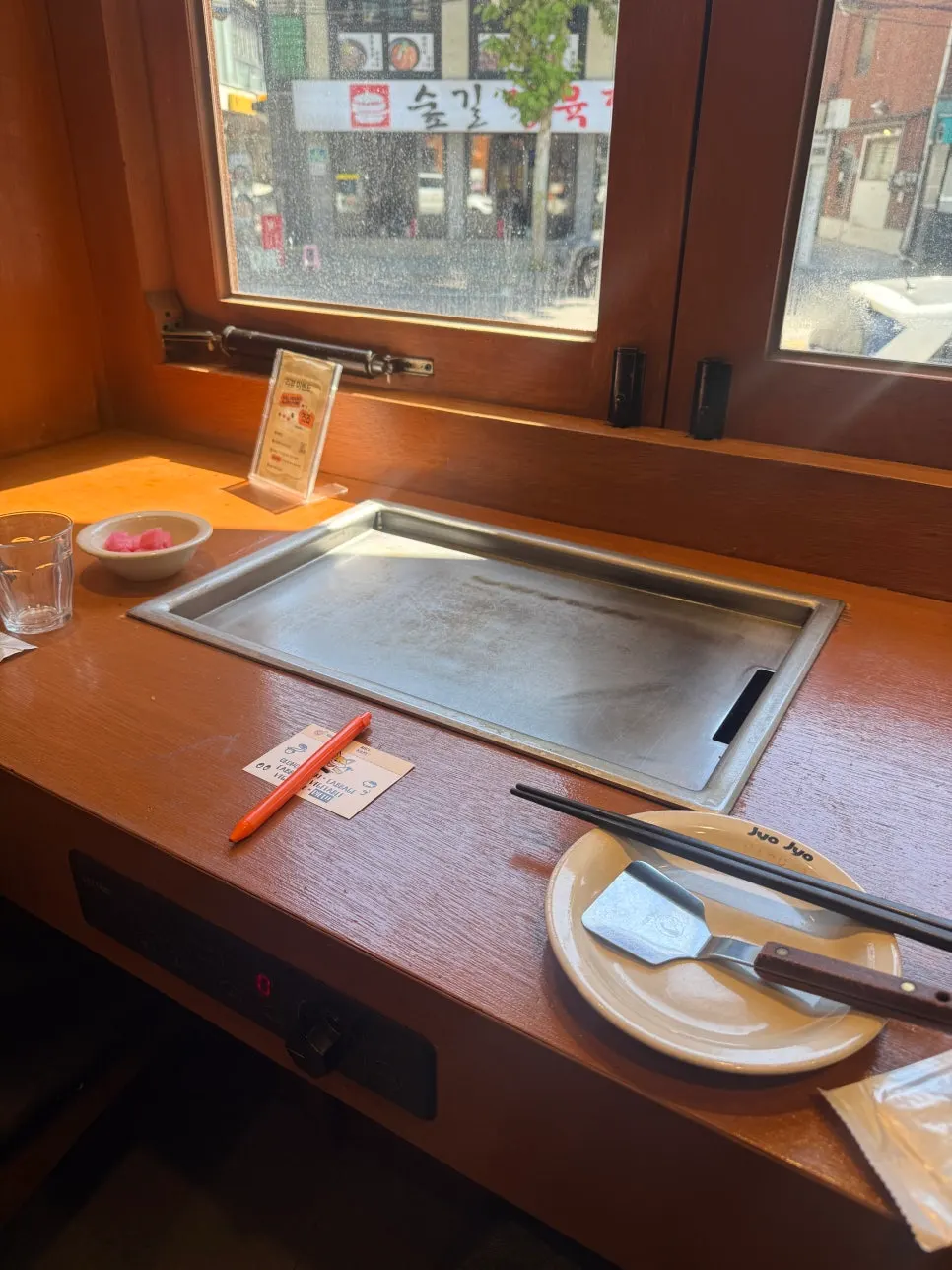 Full view of the restaurant with individual griddles at every table