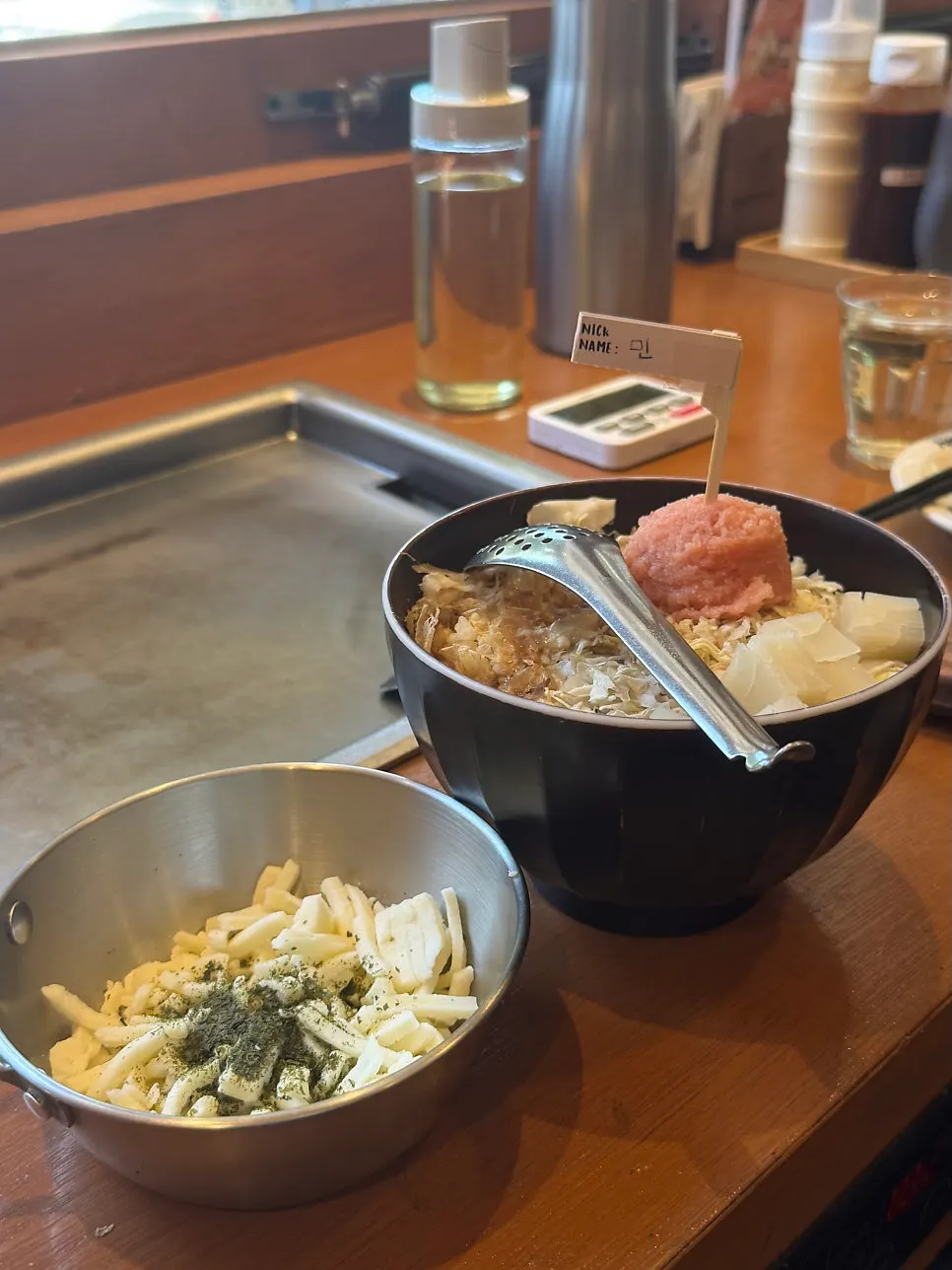 Three sauces set out for the monjayaki