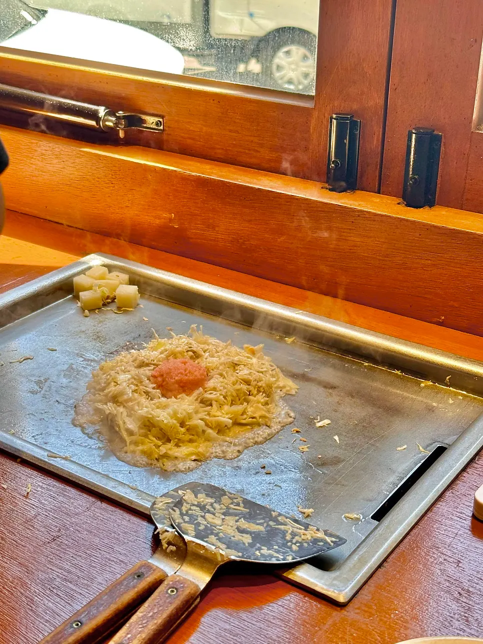 Ingredients being placed on the griddle to cook