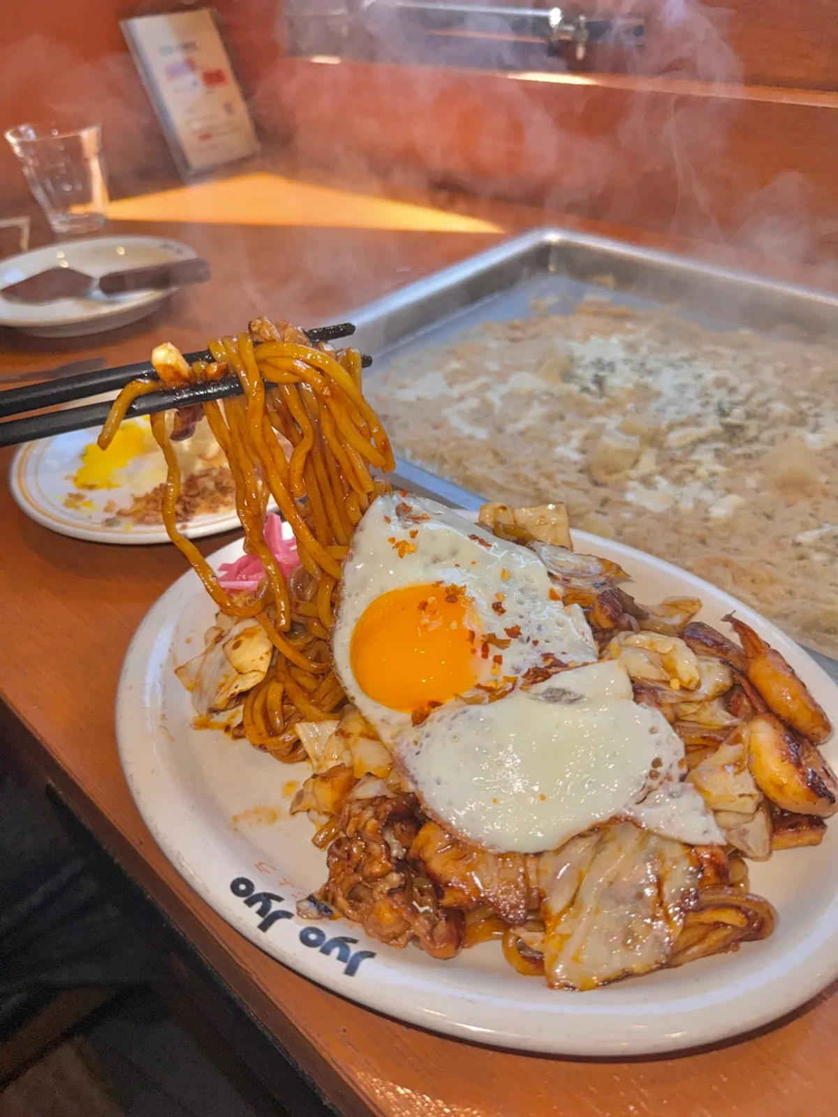 Spicy yaki udon topped with a fried egg