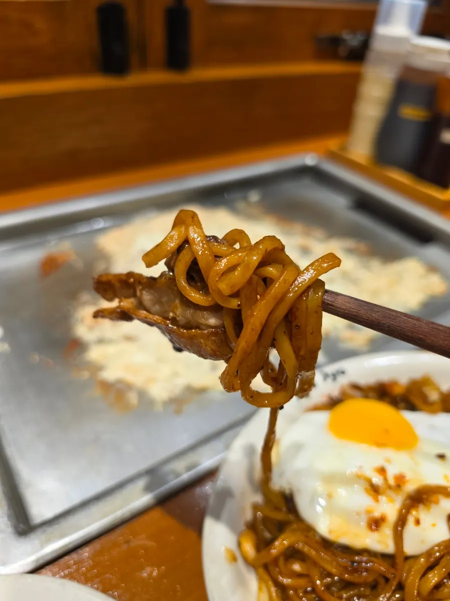 Picking up a bite of spicy yakisoba