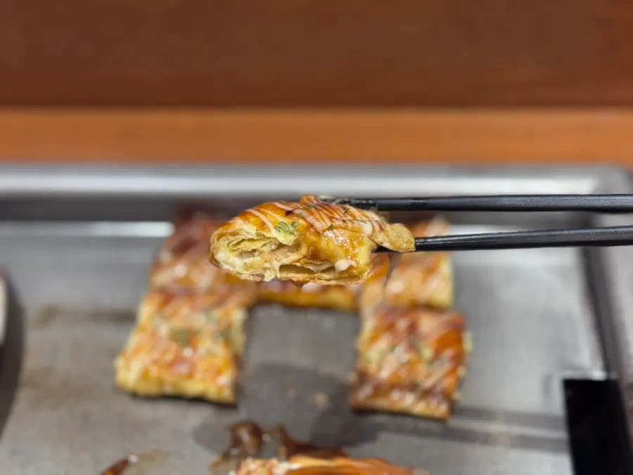 Cross-section of donpeiyaki with pork belly and cheese