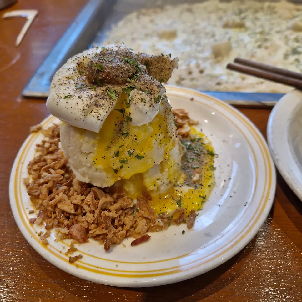 A bite of volcano potato mixed with egg yolk