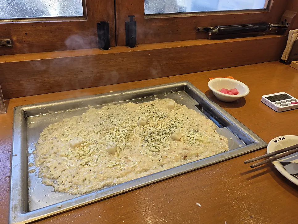 Close-up of the finished mentaiko monjayaki on the griddle