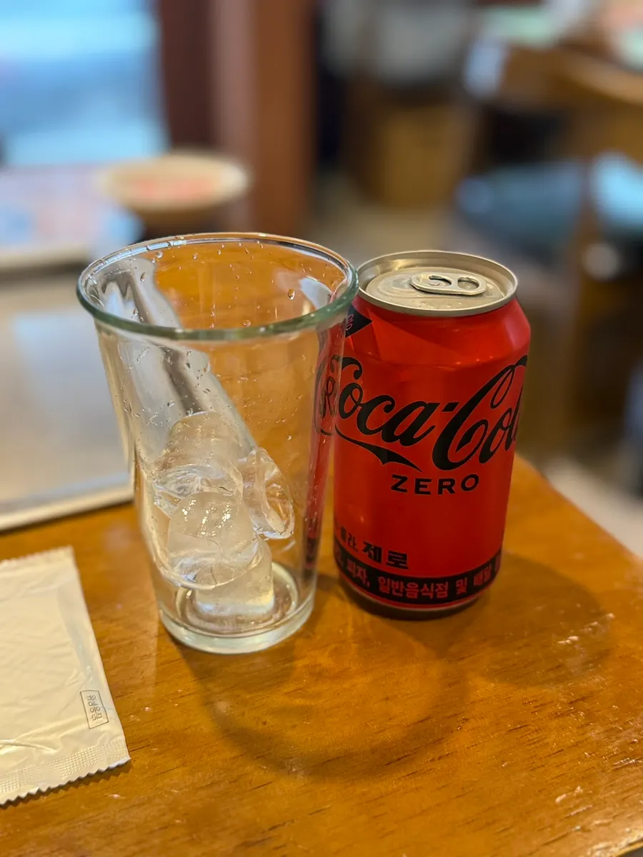 Cup of ice served alongside a Coke