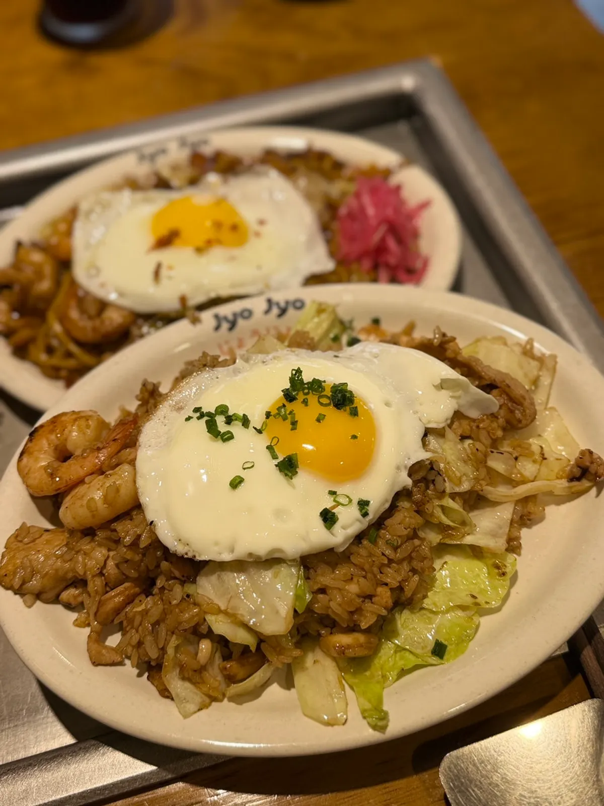 Teppan dish topped with a soft-fried egg