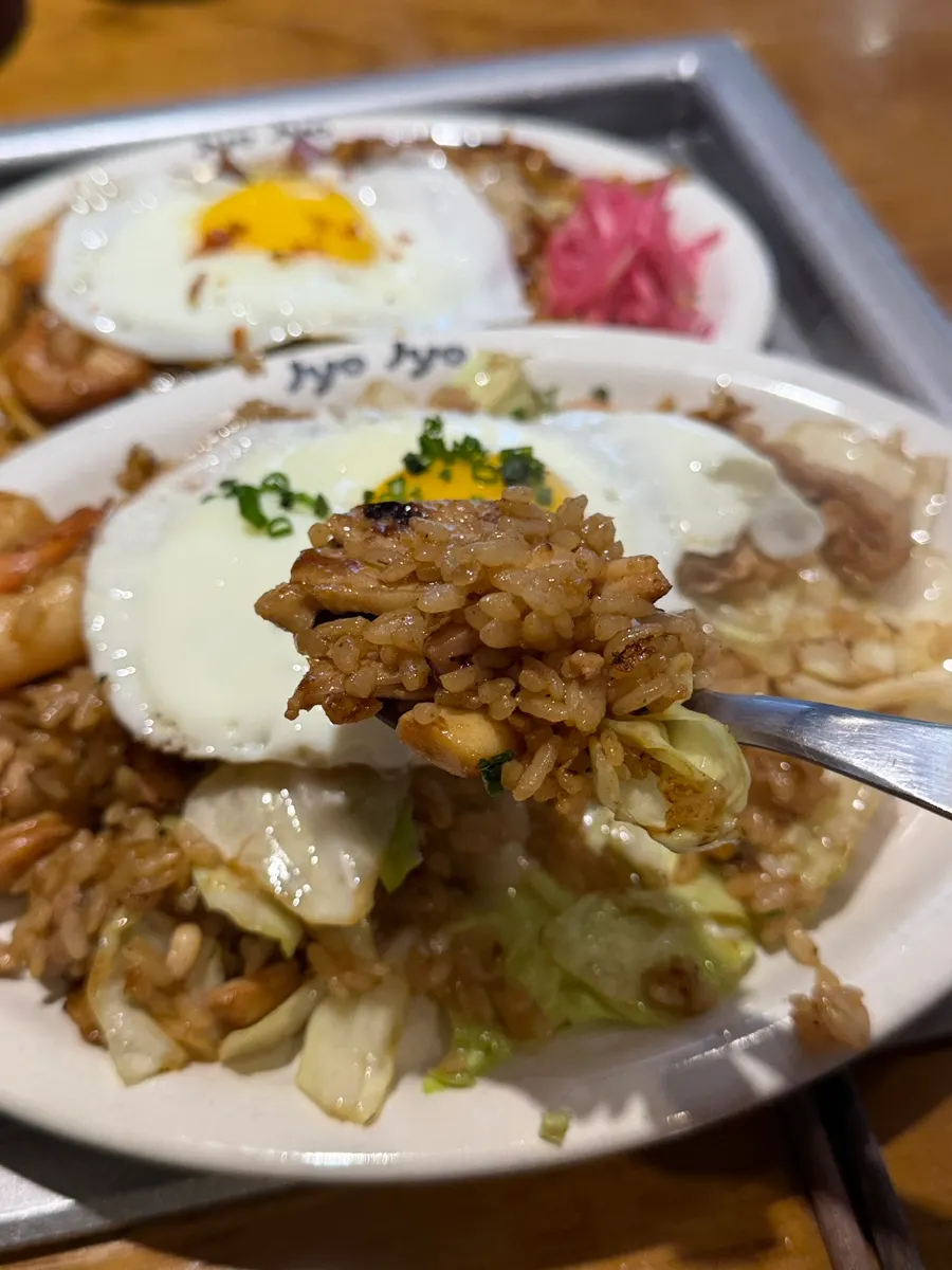 A bite of teppan food dipped in sauce