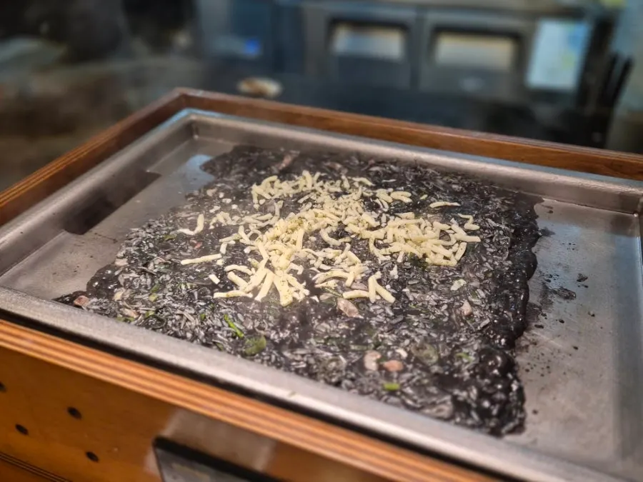 Monjayaki cooking to a deep squid ink color