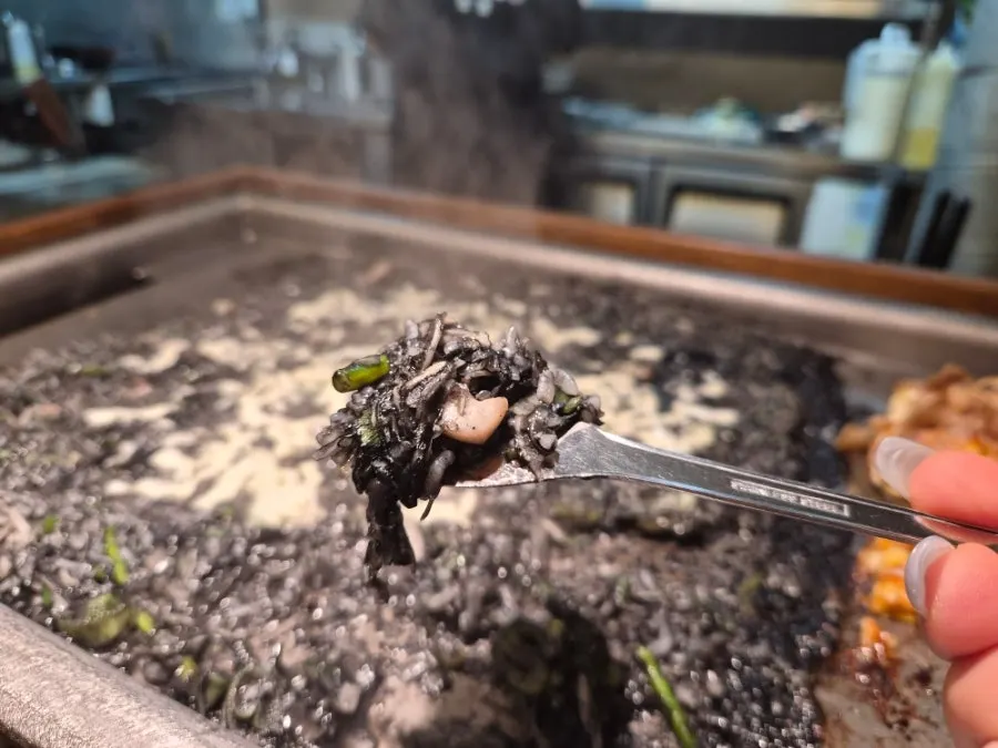 Rice grains crisping onto the griddle from the monjayaki
