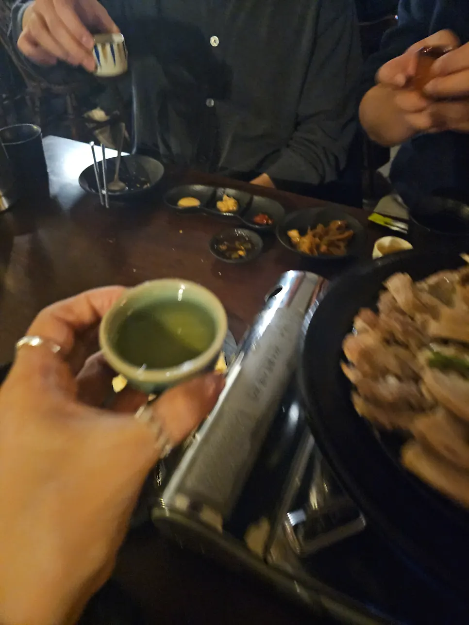 A bottle and glass of traditional liquor drunk at Jojomomo