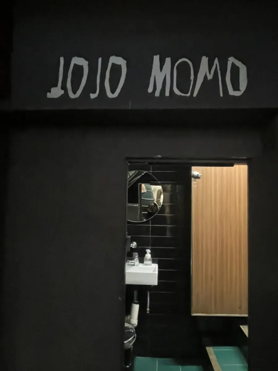 Entrance to the restroom at the bottom of the stairs at Jojomomo