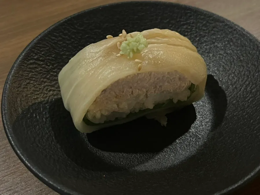 Aged kimchi tuna roll size compared with a fist