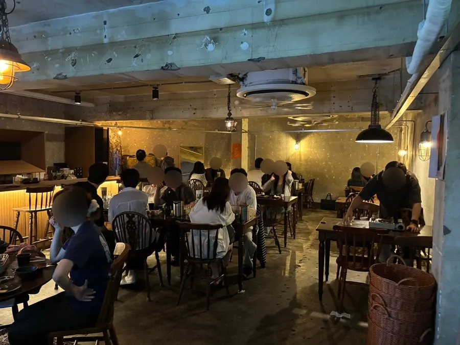 Inside Jojomomo with a light fixture at each table