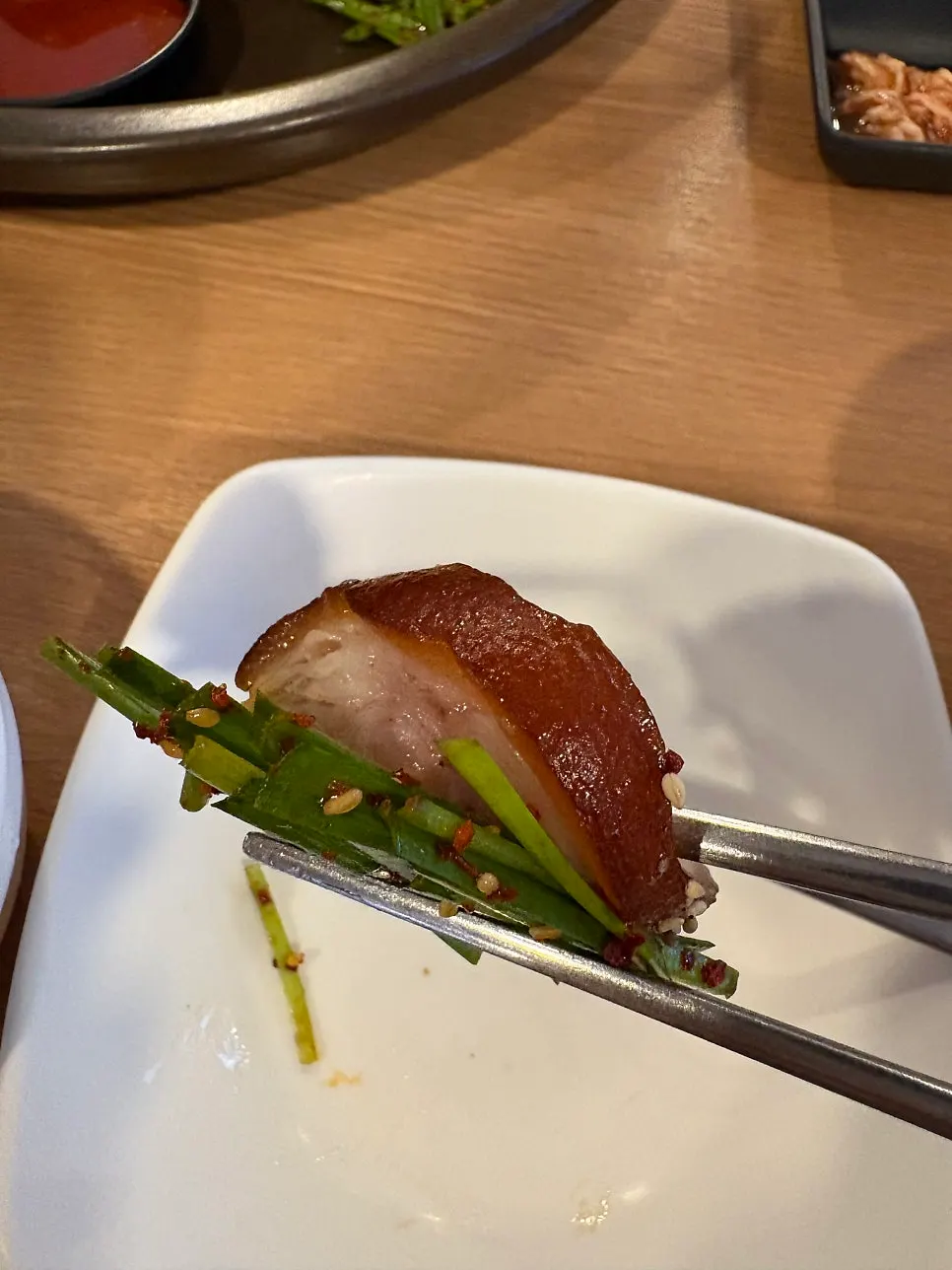 A piece of jokbal paired with crunchy vegetables