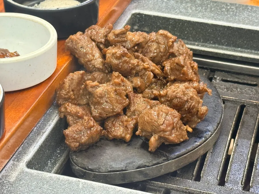 Grilled sogalbisal placed on a hot stone plate