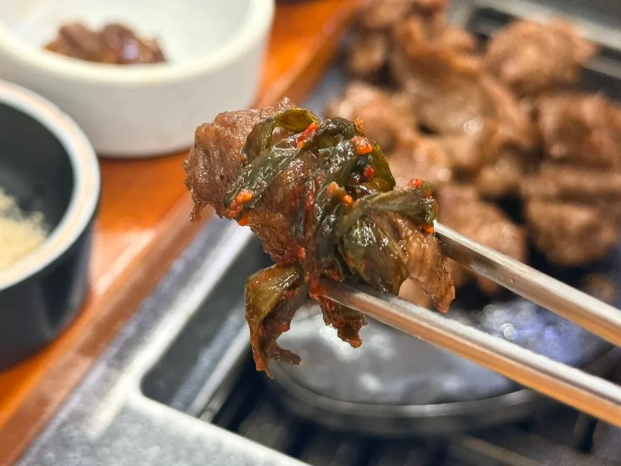 A piece of sogalbisal served with scallion kimchi and myeongnan