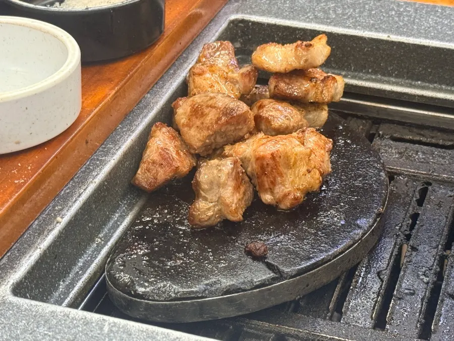 Pork neck cut into bite-sized pieces and grilled
