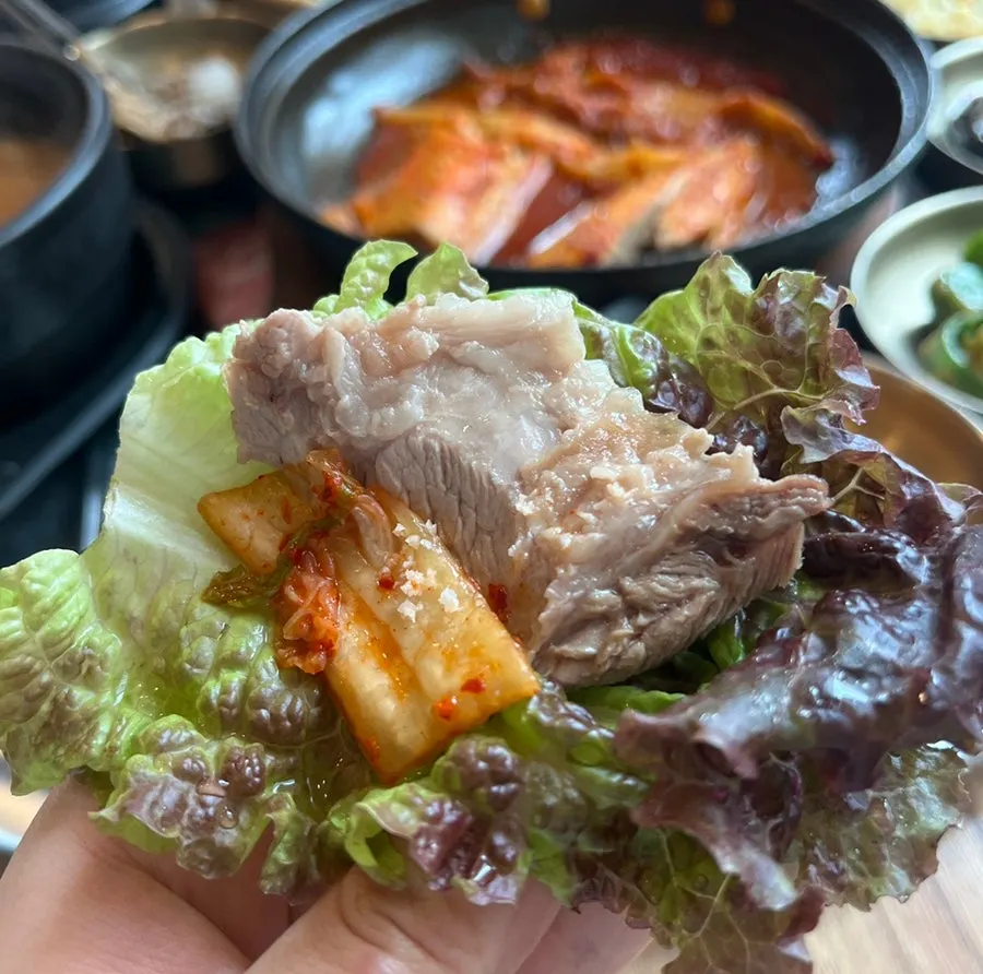 A bite of braised mackerel with aged kimchi