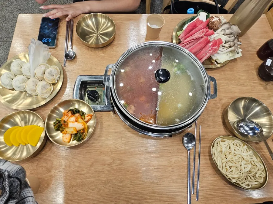 Table set with banchan and mandu hot pot