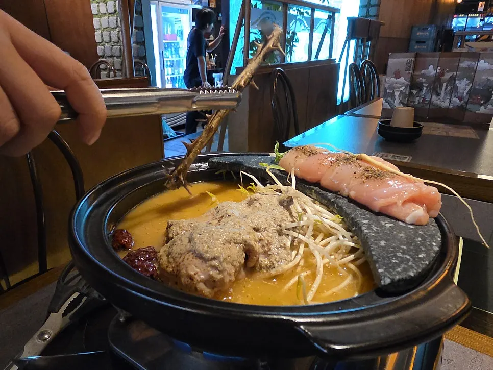 Close-up of the rich broth in the perilla chicken hot pot