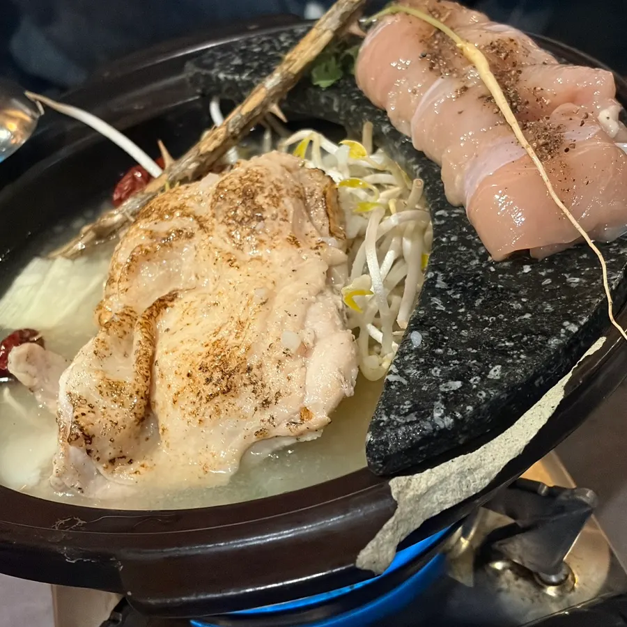 Original chicken hot pot topped with chicken thigh meat, glass noodles, and bean sprouts