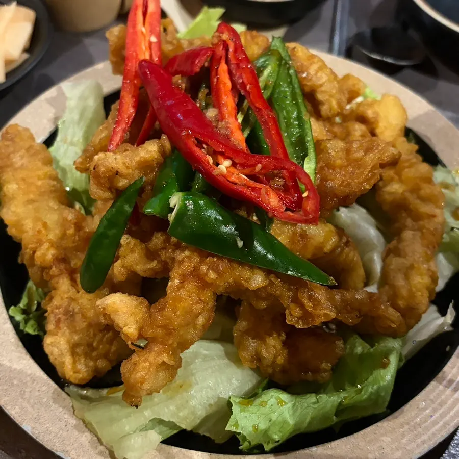 Raw chicken tenderloin served on a stone plate