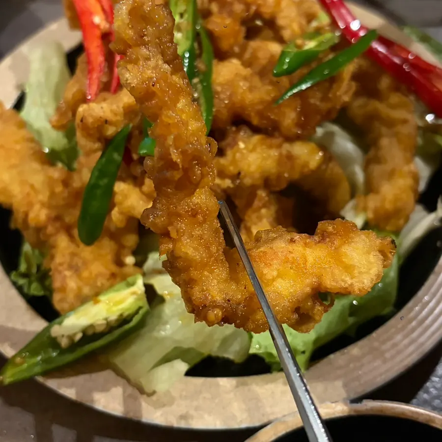 A plate of chicken thigh yurinki topped with chili