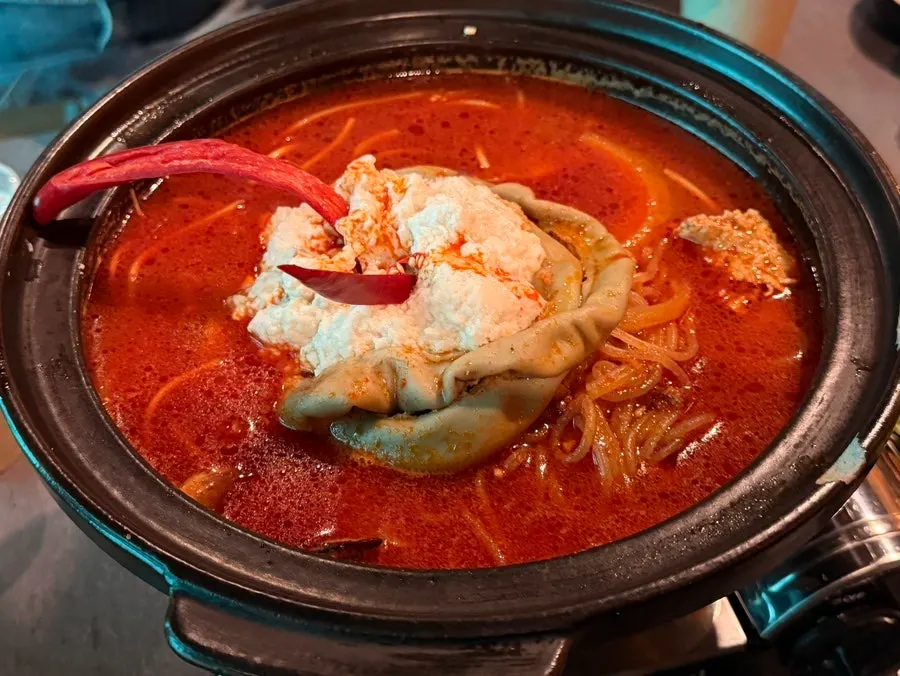 Pot of soft tofu hot pot piled high with beef tripe