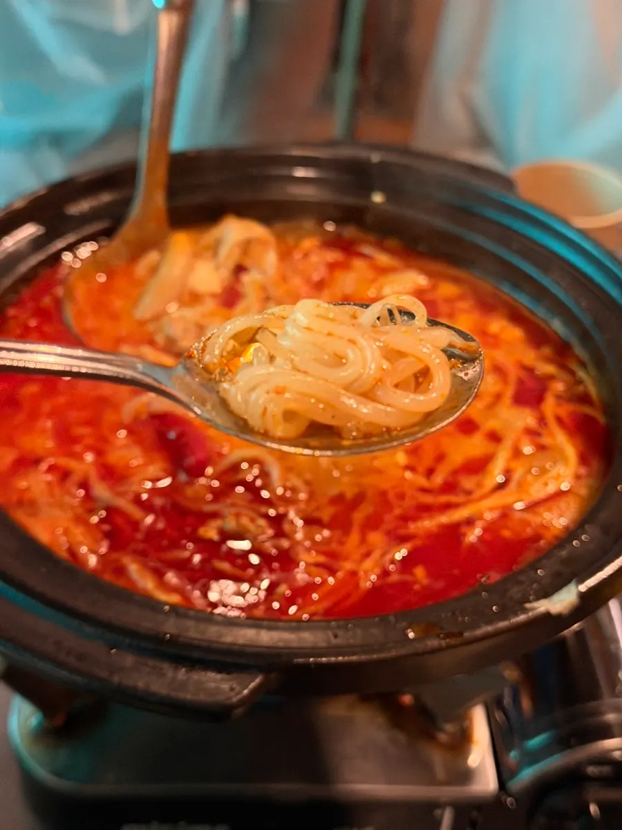 Simmering the beef tripe soft tofu hot pot on the burner