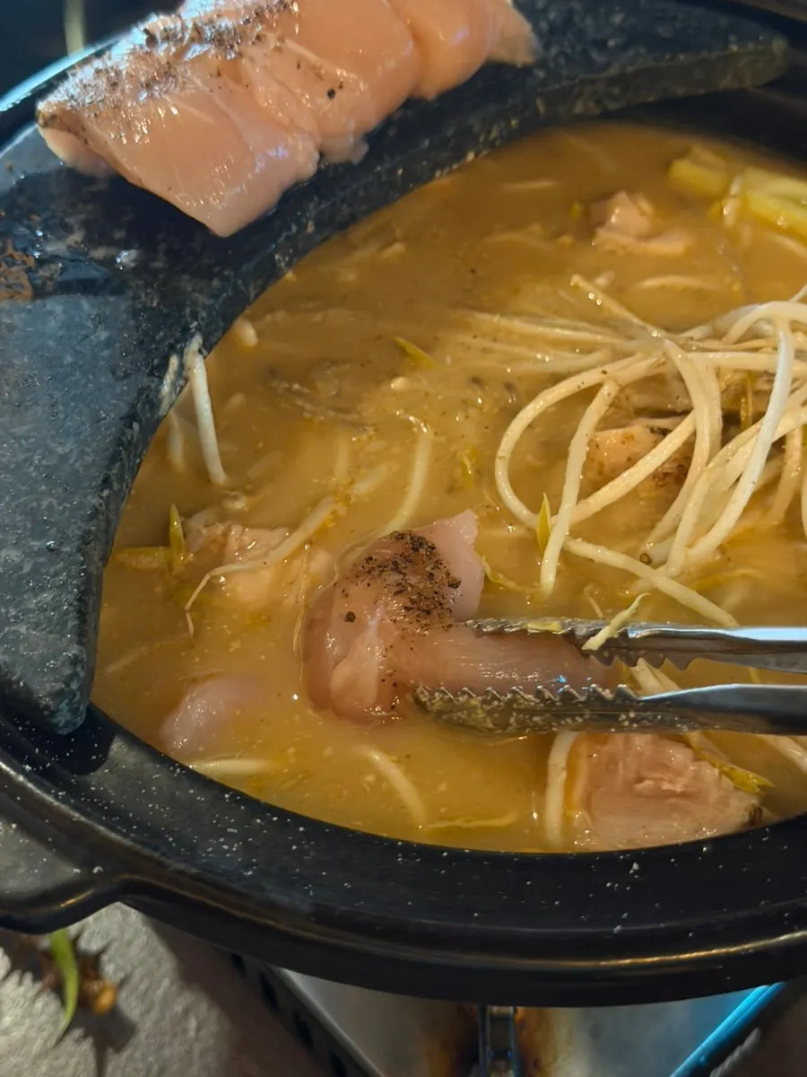 The perilla chicken hot pot boiling on a stone plate