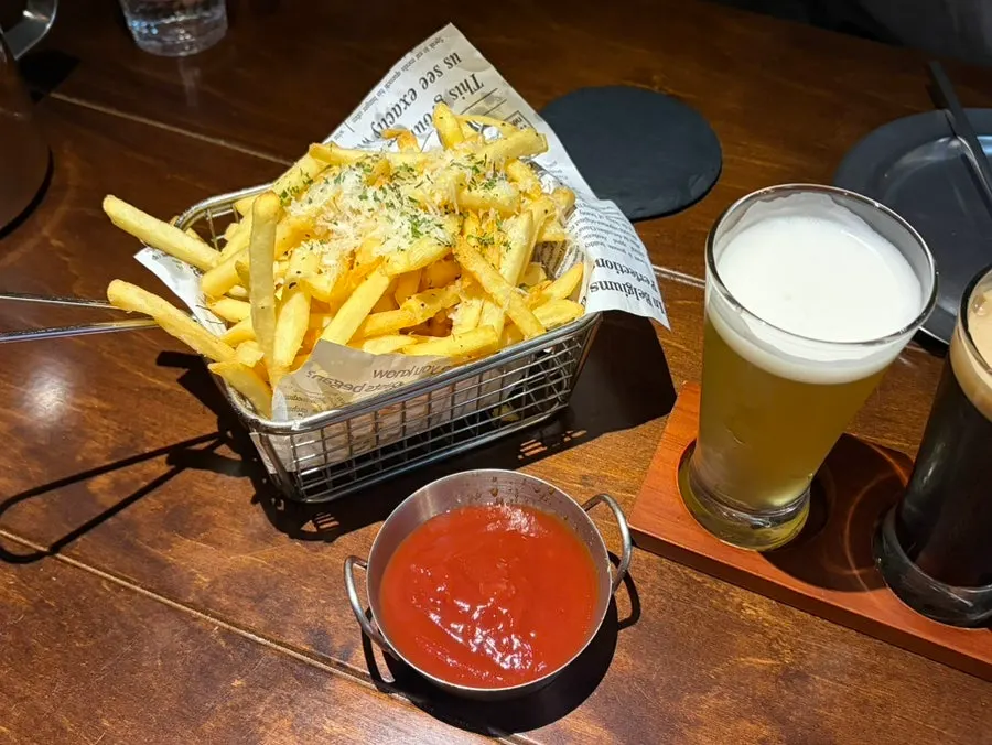 Truffle fries topped with grated cheese, served with ketchup