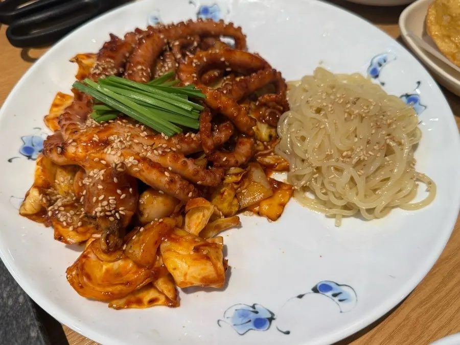 Table set with octopus stir-fry and jjolmyeon noodles