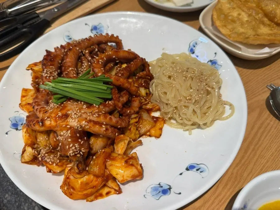 Close-up of octopus stir-fry topped with whole octopus