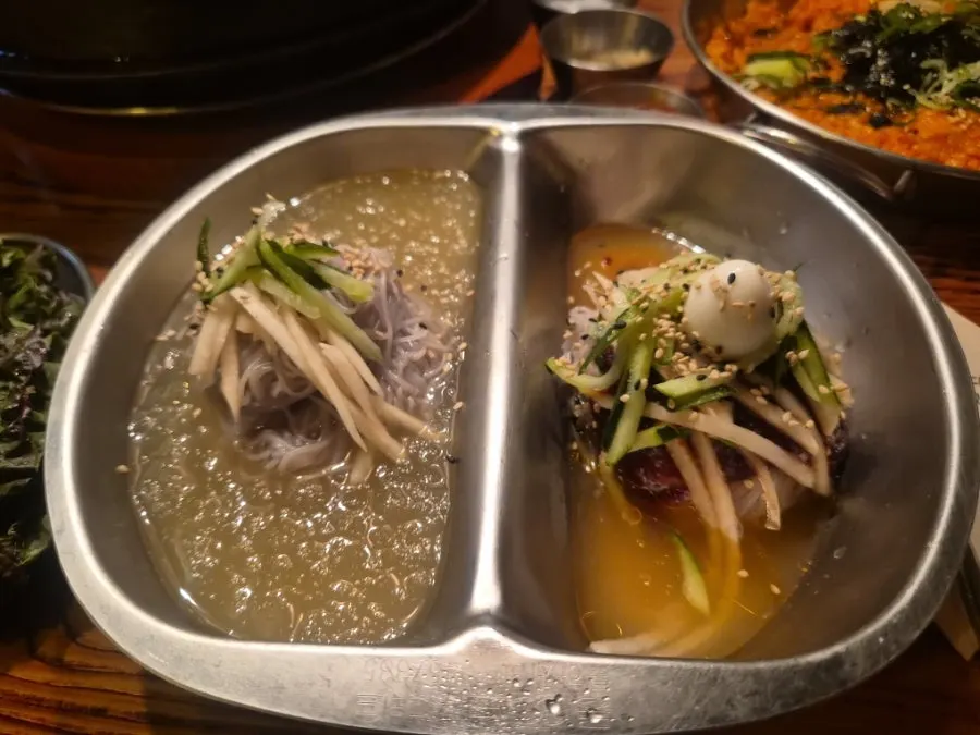 Half-and-half naengmyeon with broth and spicy styles