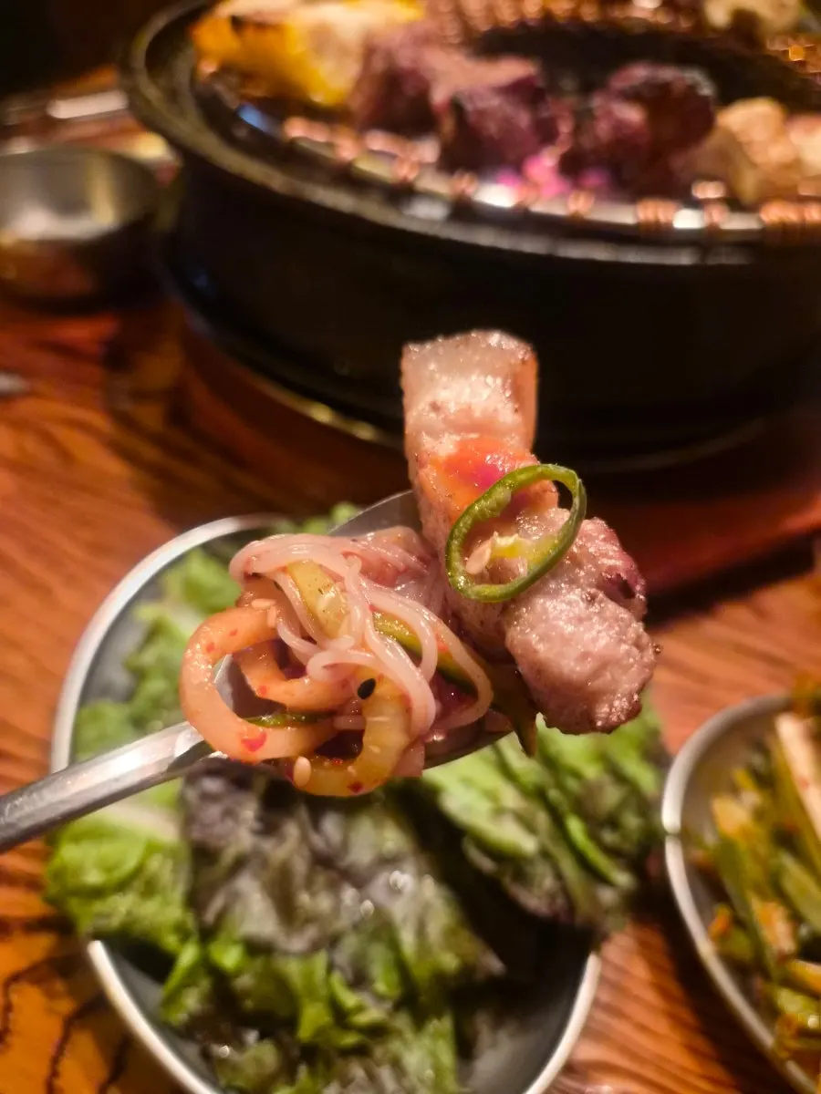 Bibim naengmyeon topped with cucumber and shredded radish