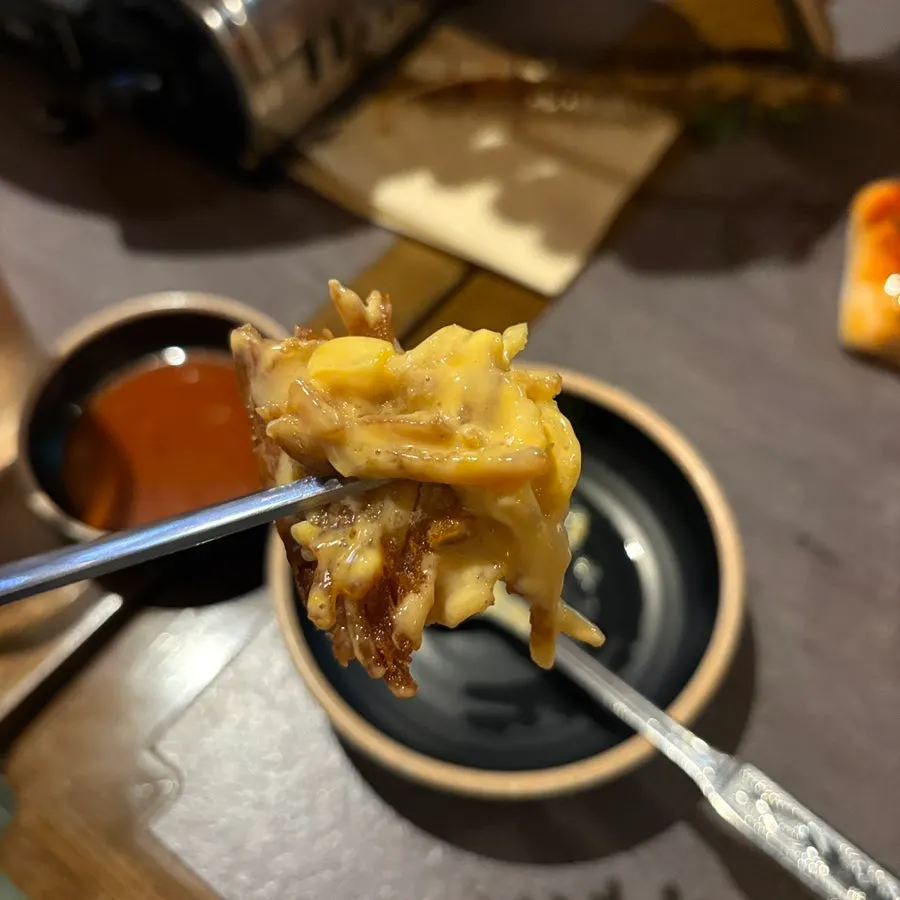 A crispy cheese-covered piece of the potato pancake