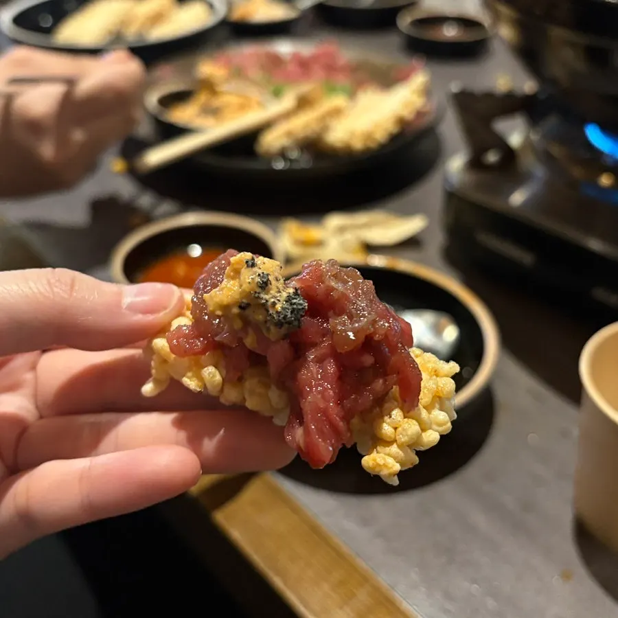 A bite of hoe topped with monkfish liver