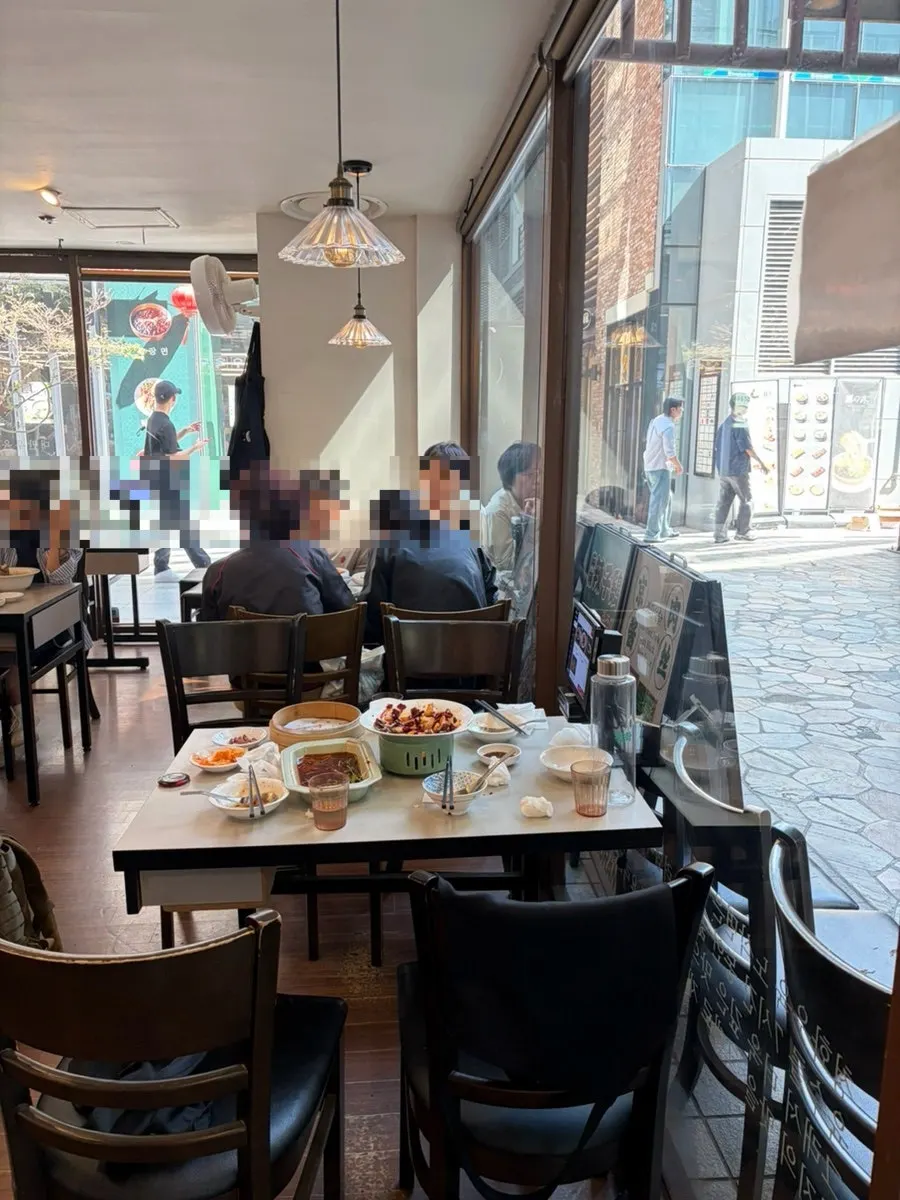 Interior of Cheonghwa Uyuk Dosakmyeon busy with weekend customers