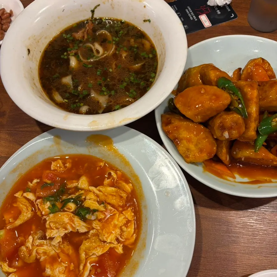 Table set with uyuk dosakmyeon and side dishes