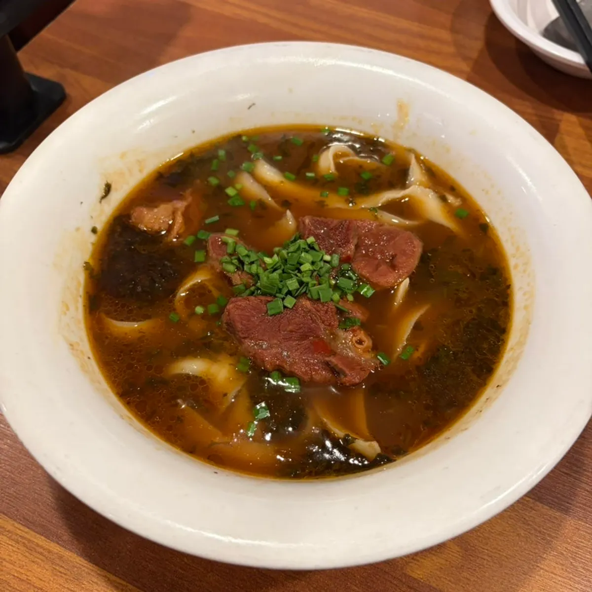 A bowl of rich-broth uyuk dosakmyeon