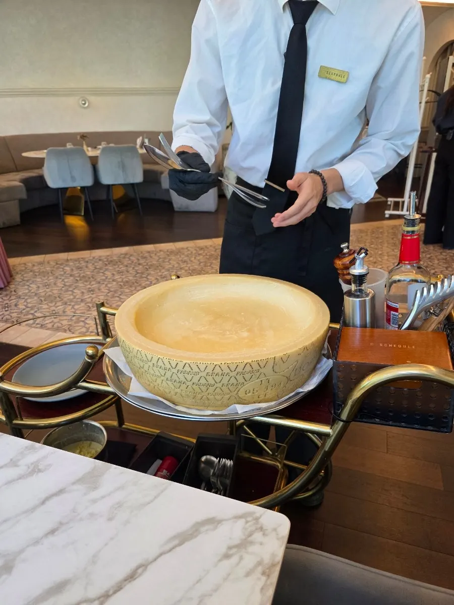 Cheese-wheel tagliatelle being prepared