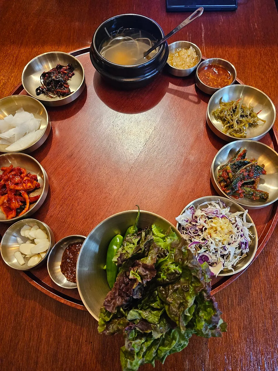 Full spread of side dishes on a round table