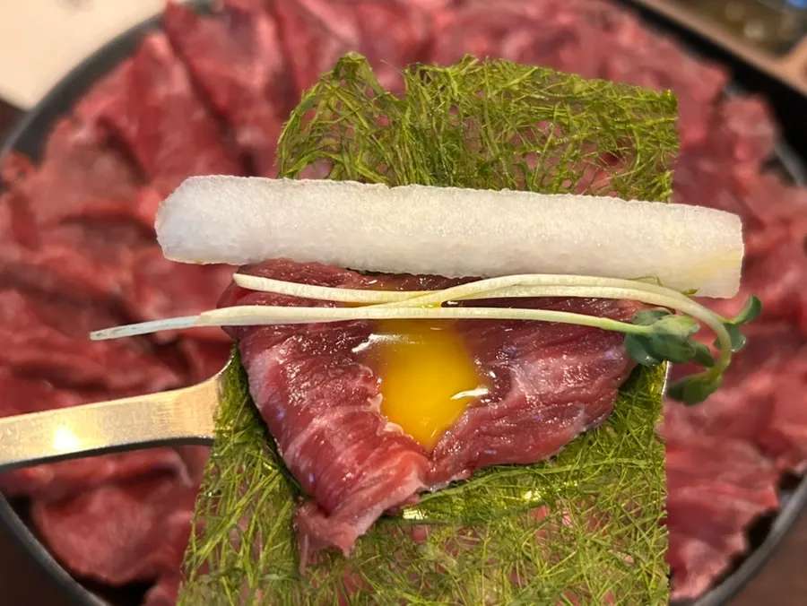 Side dishes of pear, radish sprouts, gamtae and egg yolk