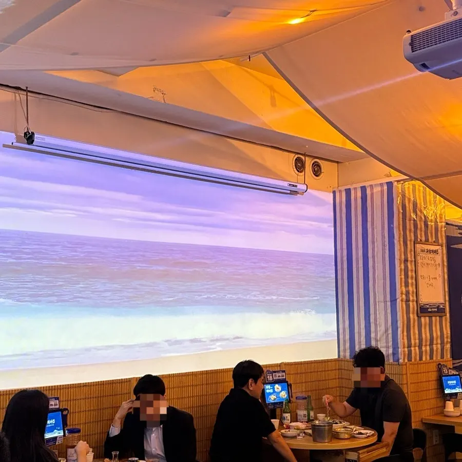 Hall seating with an LED ocean screen on the wall