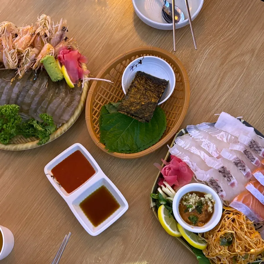 Table spread with aged sashimi combo (small) and raw shrimp sashimi