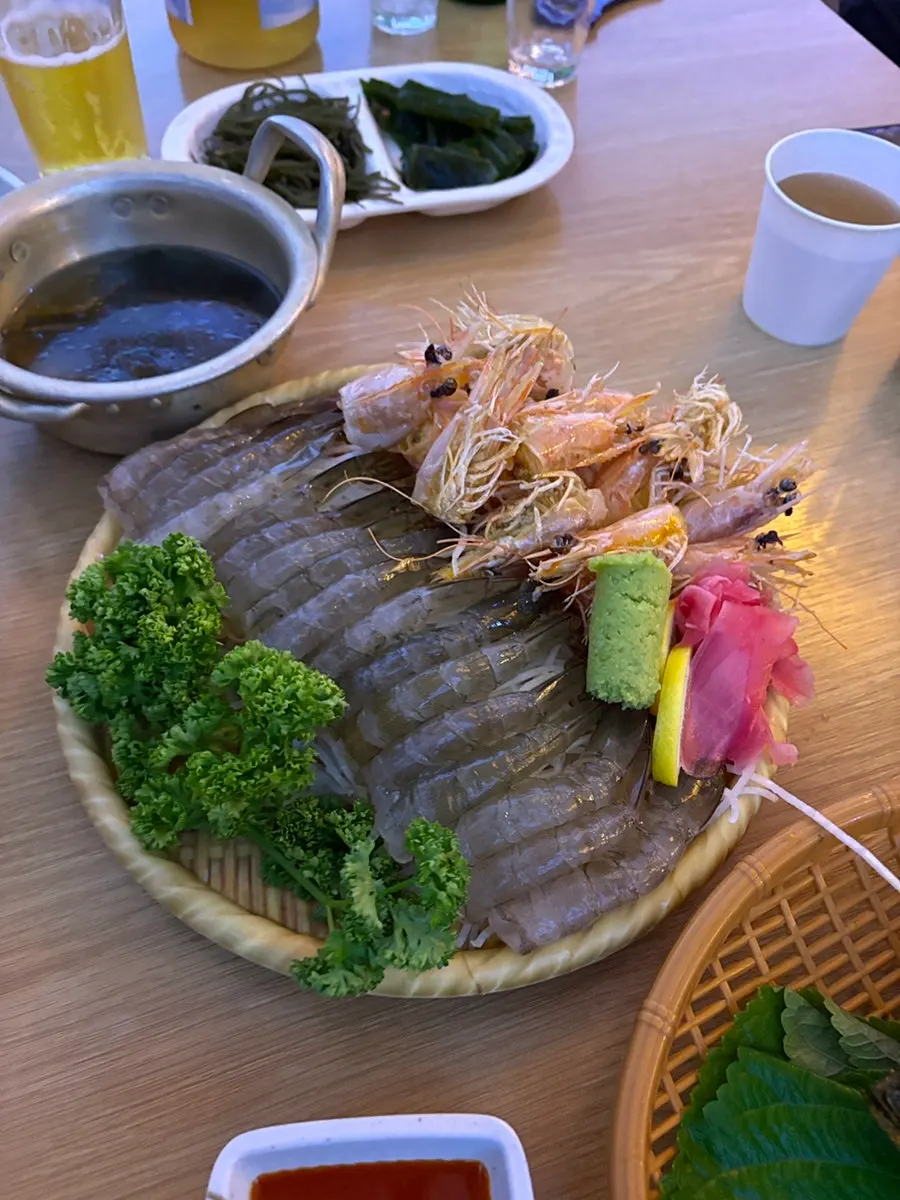 Plate of raw shrimp sashimi with chojang and wasabi