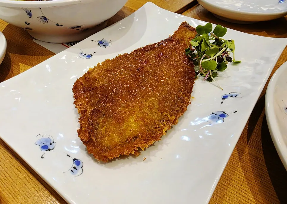 Whole fried flounder served on the table