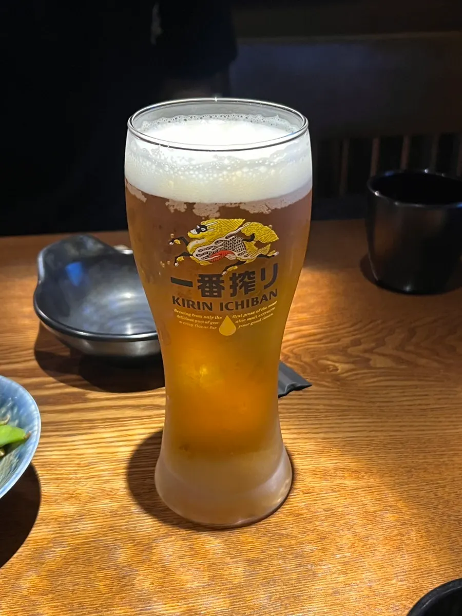 A glass of Kirin draft beer with foamy head